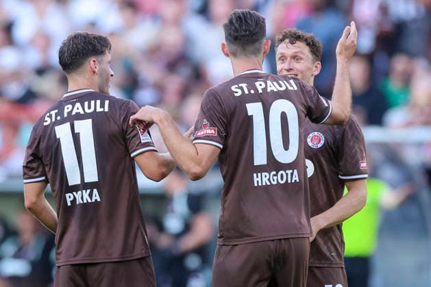 Martijn Kaars of FC St. Pauli celebrates after scoring his team s second goal alongside Arkadiusz Pyrka of FC St. Pauli and Branimir Hrgota of FC St. Pauli during the preseason friendly match between FC St. Pauli and RC Deportivo La Coruna at Millerntor Stadium on August 1, 2026 in Hamburg, Germany. Photo by Marco Steinbrenner, DeFodi Images