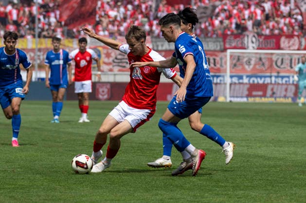 Regionalliga Northeast, Season 26–27: Hallescher FC vs. FC Rot Weiss Erfurt, Halle, Germany, August 2, 2026. Pictured, from left, in a tackle: Juien Dammelang (Halle) and Niclas Walther (Erfurt). Halle-Saale-Leuna Chemie Stadium, Saxony-Anhalt, Germany