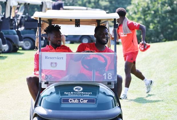GER, Bayer 04 Leverkusen Training Camp in Blankenhain, August 3, 2026, Blankenhain, GER, 2026–2027 Season, Bundesliga 1, Bayer 04 Leverkusen Training Camp in Pictures: Edmond Tapsoba and Victor Boniface with the golf caddy. DFL regulations prohibit any use of photographs as image sequences and or quasi-video.