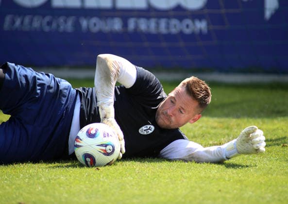 Soccer, Men s, Bavarian Regional League, 2026–2027 Season, TSV 1860 Munich, Training: Vitus Eicher of TSV 1860 Munich lying on the grass with a ball in his right hand