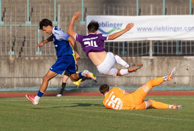 Elias Rogg, goalkeeper for TSV Schwaben Augsburg, clears the ball with Elias Herzig of TSV Schwaben Augsburg 24 in front of Shaban Veselaj of FVI TSV Schwaben Augsburg vs. FV Illertissen, Toto Cup