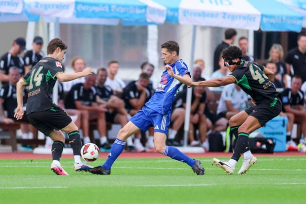 Daiki Hashioka of Borussia Mönchengladbach, Tobias Schlichtner of FC Rottach Egern, and Tyler Meiser of Borussia Mönchengladbach battle for the ball during the friendly match between FC Rottach Egern and Borussia Mönchengladbach, Birkenmoos Stadium on August 5, 2026, in Rottach Egern, Germany. Photo by Marco Steinbrenner, DeFodi Images. Daiki Hashioka of Borussia Mönchengladbach, Tobias Schlichtner of FC Rottach Egern and Tyler Meiser of Borussia Mönchengladbach battle for the ball during the friendly match between FC Rottach Egern and Borussia Mönchengladbach at Birkenmoos Stadium on August 5, 2026 in Rottach Egern, Germany Photo by Marco Steinbrenner, DeFodi Images Photo by Marco Steinbrenner, DeFodi Images