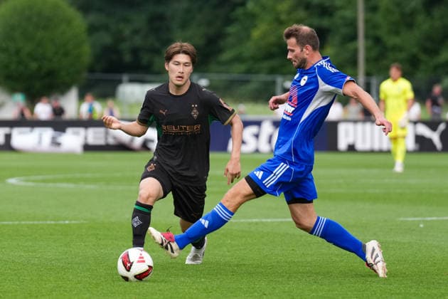 August 5, 2026, xydrx, soccer, friendly match, FC Rottach Egern vs. Borussia Mönchengladbach, 2026–2027 season, Birkenmoos Stadium, Daiki Hashioka, Borussia Mönchengladbach, No. 14 in a tackle against Florian Mex, FC Rottach Egern, No. 9. DFB regulations prohibit any use of photographs as image sequences and or quasi-video. Copyright: HMBxMedia YannisxDreimann