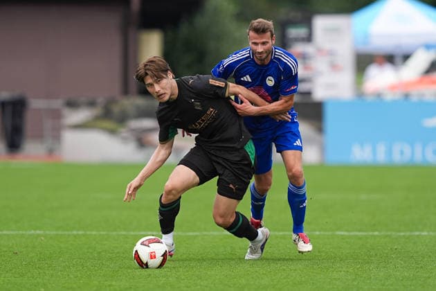 August 5, 2026, xydrx, soccer, friendly match, FC Rottach Egern vs. Borussia Mönchengladbach, 2026–2027 season, Birkenmoos Stadium, Daiki Hashioka, Borussia Mönchengladbach, No. 14 in a tackle against Florian Mex, FC Rottach Egern, No. 9. DFB regulations prohibit any use of photographs as image sequences and or quasi-video. Copyright: HMBxMedia YannisxDreimann