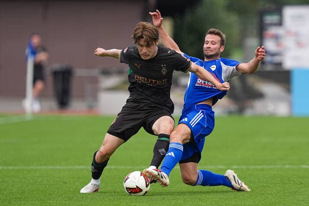 August 5, 2026, xydrx, soccer, friendly match, FC Rottach Egern vs. Borussia Mönchengladbach, 2026–2027 season, Birkenmoos Stadium, Daiki Hashioka, Borussia Mönchengladbach, No. 14 in a tackle against Florian Mex, FC Rottach Egern, No. 9. DFB regulations prohibit any use of photographs as image sequences and or quasi-video. Copyright: HMBxMedia YannisxDreimann
