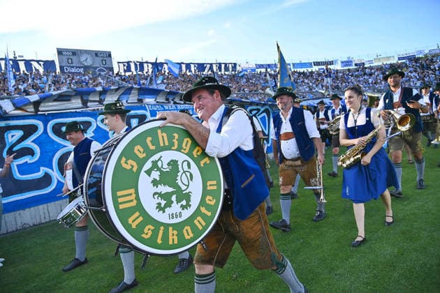 Brass band, brass music in front of the Sechzger fan section, Bavarian Regional League soccer, 2026–2027 season,Matchdays 26, 27, and 3: TSV 1860 Munich vs. FC Augsburg II on August 7, 2026, at the Grünwalder Stadium in Munich