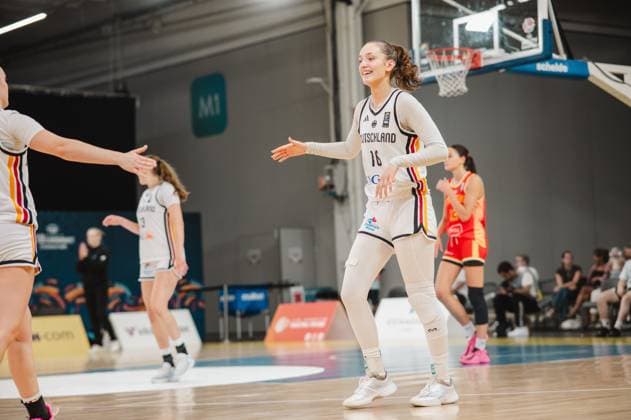 Lilli Schultze, 16, of Germany, smiles as she reaches out her hand to a teammate, clearly delighted on the court at Kistamässan in Stockholm. In the background are other German players as well as an opponent in a red jersey. Lilli Schultze, 16, of Germany, high-fiving a teammatein Copyright: xJoelxKruehlerx