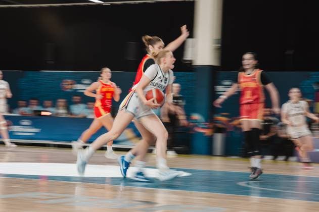 A German player drives toward the basket and is pressured by a Montenegrin player. The scene shows intense physical contact as she drives to the basket at Kistamässan in Stockholm. A German player battles a Montenegrin player on a drive to the basket. Copyright: xJoelxKruehlerx