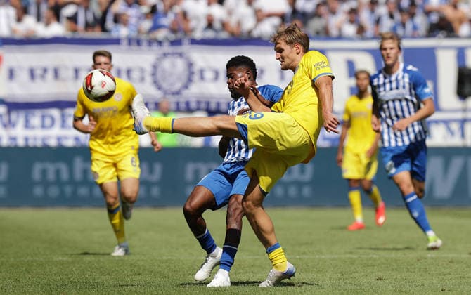Lukas Frenkert, Eintracht Braunschweig; Moritz Broni Kwarteng, 1. FC Magdeburg; Soccer, Men s, 2026–2027 Season, 2. Bundesliga, Avnet Arena, Matchday 1, 1 FC Magdeburg vs. Eintracht Braunschweig DFL REGULATIONS PROHIBIT ANY USE OF PHOTOGRAPHS AS IMAGE SEQUENCES AND OR QUASI-VIDEO