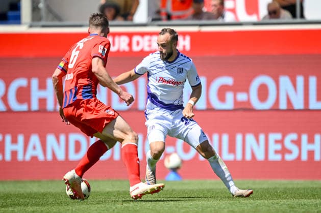 Patrick Mainka of 1 FC Heidenheim 1846 and David Kopacz of VfL Osnabrück go head-to-head during the 2. Bundesliga match between 1 FC Heidenheim and VfL Osnabrück, at the Voith Arena on August 8, 2026, in Heidenheim an der Brenz, Germany. Photo by Harry Langer, DeFodi Images. Patrick Mainka of 1 FC Heidenheim 1846 and David Kopacz of VfL Osnabrück battle for the ball during the 2. Bundesliga match between 1 FC Heidenheim and VfL Osnabrück at Voith Arena on August 8, 2026 in Heidenheim an der Brenz, Germany. Photo by Harry Langer, DeFodi Images. DFB and DFL regulations prohibit any use of photographs as image sequences and or quasi-video. Photo by Harry Langer, DeFodi Images. DFB and DFL regulations prohibit any use of photographs as imSEQUENCES AND OR QUASI-VIDEO