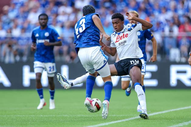 August 8, 2026, Soccer, FC Schalke 04 vs. Atalanta Bergamo, Friendly Match, Veltins Arena, Gelsenkirchen, 2026–2027 season: Mertcan Ayhan (FC Schalke 04, No. 43) in a tackle against Honest Ahanor (Atalanta Bergamo, No. 69). DFB regulations prohibit any use of photographs as image sequences and or quasi-video. North Rhine-Westphalia, Germany