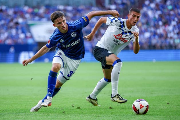 August 8, 2026, Soccer, FC Schalke 04 vs. Atalanta Bergamo, Friendly Match, Veltins Arena, Gelsenkirchen, 2026–2027 season: Frederico Cassa (Atalanta Bergamo, No. 49) in a tackle against Vitalie Becker (FC Schalke 04, No. 33). DFB regulations prohibit any use of photographs as image sequences and or quasi-video. North Rhine-Westphalia, Germany