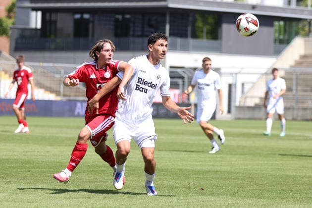 August 8, 2026, Men s Soccer, 2026–2027 Season, Bavarian Regional League, Matchday 3: FC Bayern Munich II vs. FC Schweinfurt 05. From left: Bohdan Olychenko (FC Bayern Munich II), 06, against Mustafa Alper Özden (FC Schweinfurt 05), 20. Munich, Municipal Stadium an der Grü, Bavaria, Germany