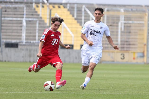 August 8, 2026, Men s Soccer, 2026–2027 Season, Bavarian Regional League, Matchday 3: FC Bayern Munich II vs. FC Schweinfurt 05. From left: Bohdan Olychenko (FC Bayern Munich II), 06, against Mustafa Alper Özden (FC Schweinfurt 05), 20. Munich, Municipal Stadium an der Grü, Bavaria, Germany