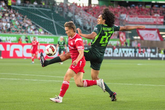 August 8, 2026 Men s Soccer 2026–2027 2. Bundesliga Matchday 1 VfL Wolfsburg 1 FC Kaiserslautern Volkswagen Arena, Wolfsburg Mathys Angely (Wolfsburg), 22, green, is unable to clear the ball past Naatan Skyttä of Kaiserslautern, 15, red, Wolfsburg, Lower Saxony, Germany