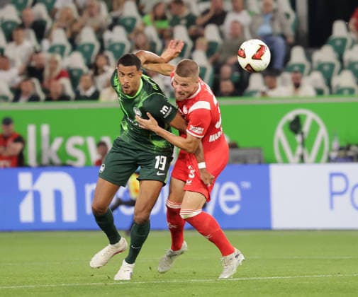 Robert Glatzel, VfL Wolfsburg; Jan Elvedi, 1. FC Kaiserslautern; Soccer, Men s, 2026–2027 Season, 2. Bundesliga, Volkswagen Arena, VfL Wolfsburg vs. 1. FC Kaiserslautern 0–0. DFL regulations prohibit any use of photographs as image sequences and or quasi-video.
