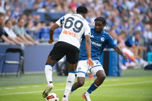Junior DINA EBIMBE GE vs. Homest AHANOR AB Action, Tackle, Soccer Friendly Match: FC Schalke 04 vs. Atalanta Bergamo 0–3 on August 8, 2026, at the Veltins Arena in Gelsenkirchen, Germany. DFL regulations prohibit any use of photographs as image sequences and or quasi-video.