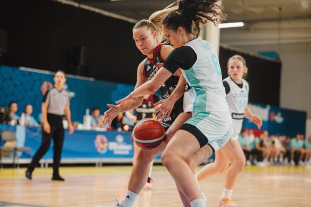 Darina Zraychenko 8 of Germany is locked in a fierce battle for the ball with a player from Slovenia. In the background, a female referee and other players from both teams can be seen. Darina Zraychenko 8 of Germany battles for the ball against Slovenia. Copyright: xJoelxKruehlerx
