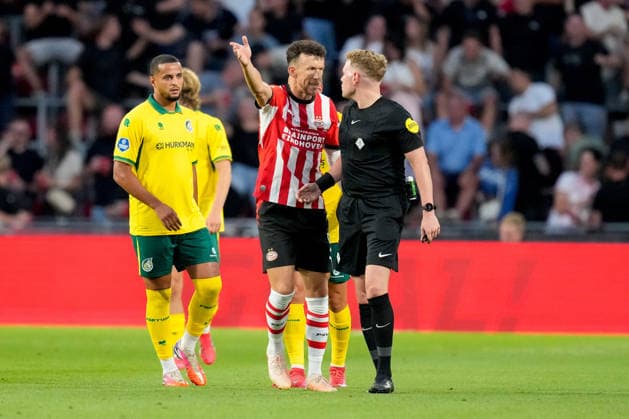 Ivan Perisic of PSV Eindhoven and referee Alex Bos discuss during the 2026-27 Eredivisie match between PSV and Fortuna Sittard at Philips Stadion on August 8, 2026, in Eindhoven, Netherlands. Photo by Alex Gottschalk, DeFodi Images