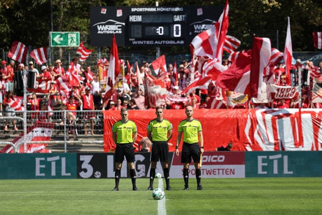 August 8, 2026, xsefx, Soccer, FC Viktoria Köln vs. SSV Jahn Regensburg, 3rd Division, Sportpark Höhenberg, Matchday 1, 2026–2027 Season. Referee Lennart Kernchen, Julian Bergmann on the right and Mika Jungclaus on the left during the moment of silence for Günter Pütz, the former president of FC Viktoria Köln 1904 e.V. DFB regulations prohibit any use of photographs as image sequences and or quasi-video. North Rhine-Westphalia, Germany