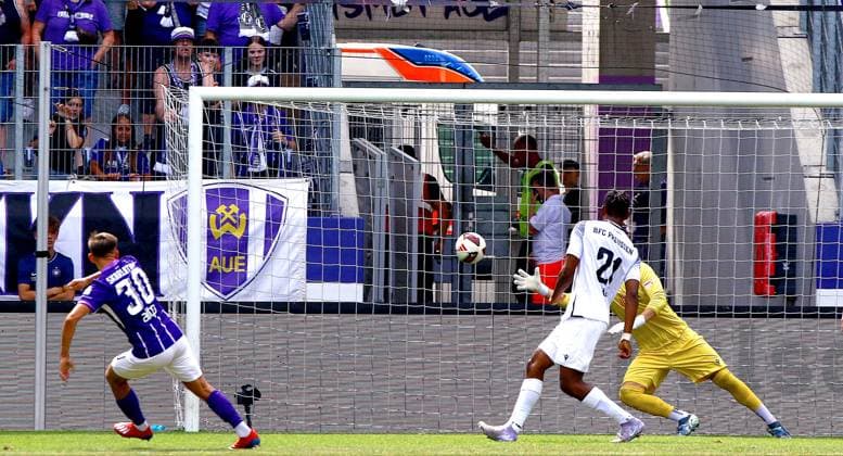 Simon Skarlatidis of Aue beats goalkeeper Florian Palmowski of BFC Preussen on the left to make it 1–0. Soccer, Northeast Regional League 2026–27: FC Erzgebirge Aue vs. BFC Preussen on August 9, 2026. Erzgebirge Aue vs. BFC Preussen