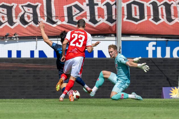 Regionalliga Northeast, Season 26–27: Hallescher FC vs. Chemnitzer FC, Halle, Germany, August 9, 2026. Pictured, from left: Domenico Alberico (Chemnitz), Marius Hauptmann (Halle), and goalkeeper Luca Bendel (Halle). Halle-Saale Leuna Chemie Stadium, Saxony-Anhalt, Germany
