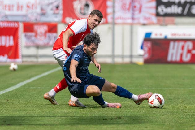 Regionalliga Northeast, Season 26–27: Hallescher FC vs. Chemnitzer FC, Halle, Germany, August 9, 2026. Pictured, from left, in a tackle: Marius Hauptmann (Halle) and Domenico Alberico (Chemnitz). Halle-Saale-Leuna Chemie Stadium, Saxony-Anhalt, Germany
