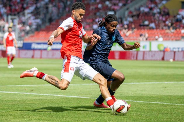Regionalliga Northeast, Season 26–27: Hallescher FC vs. Chemnitzer FC, Halle, Germany, August 9, 2026. Pictured, from left, in a tackle: Stanley Ratifo (Halle) and Ken Tchouangue (Chemnitz). Halle Saale Leuna Chemie Stadium, Saxony-Anhalt, Germany