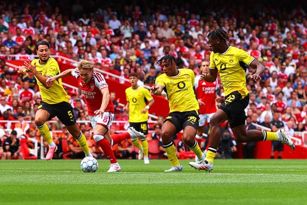 Martin Odegaard of Arsenal is fouled by Filippo Mane of Borussia Dortmund during the preseason friendly match between Arsenal FC and Borussia Dortmund at Emirates Stadium on August 9, 2026, in London, England. Photo by Ryan Crockett, DeFodi Images
