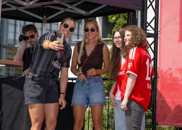 August 9, 2026, Google Pixel Women s Bundesliga Friendly Match: FC Bayern Women vs. Paris FC, at Sportpark Unterhaching, fan festival in front of the stadium, meet-and-greet with players Vaness Gilles (left), FC Bayern, and Giulia Gwinn (center), FC Bayern, and the fans