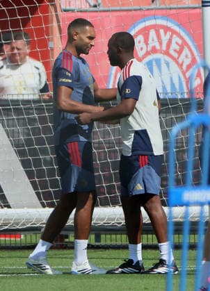 August 10, 2026, FC Bayern Training, Saebenerstrasse, Munich, Soccer, Sports; Pictured: Jonathan Tah of FC Bayern Munich and Floribert NGalula of FC Bayern Munich greet each other
