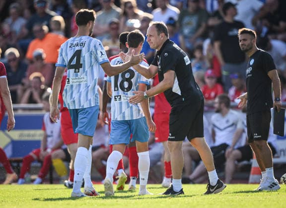 Soccer WFV Cup 2026–2027, Round 3, August 11, 2026: FC Rottenburg vs. SV Stuttgarter Kickers. Kickers coach Holger Bachthaler (center) high-fives Elvir Zukaj (left, No. 4) of the Kickers.