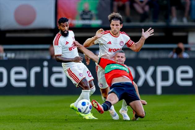NIJMEGEN N E C Nijmegen forward Bryan Linssen and Olympiacos Piraeus defender Panagiotis Retsos during the Champions League match between N E C and Olympiacos at De Goffert Stadium on August 11, 2026, in Nijmegen, the Netherlands