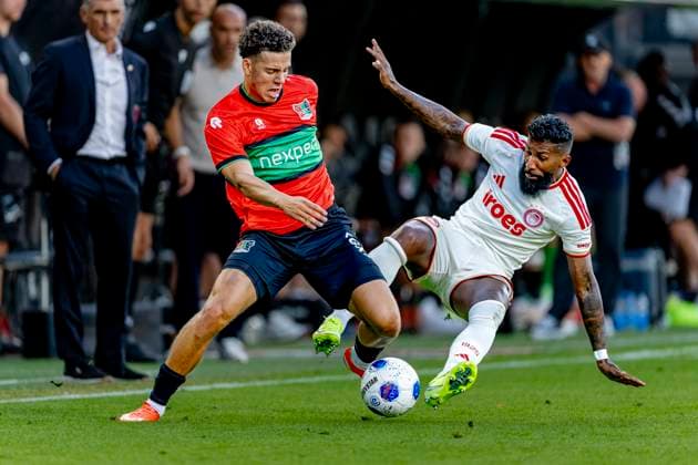 NIJMEGEN N E C Nijmegen defender Clement Bischoff and Olympiacos Piraeus defender Rodinei during the Champions League match between N E C and Olympiacos at De Goffert Stadium on August 11, 2026, in Nijmegen, the Netherlands