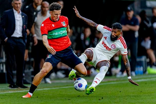 NIJMEGEN N E C Nijmegen defender Clement Bischoff and Olympiacos Piraeus defender Rodinei during the Champions League match between N E C and Olympiacos at De Goffert Stadium on August 11, 2026, in Nijmegen, the Netherlands