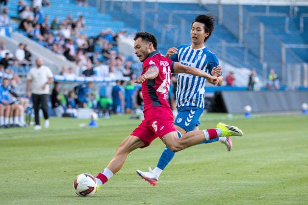 August 11, 2026 Men s Soccer 2026–2027 Northeast Regional League, Matchday 4: 1. FC Magdeburg II vs. SV Babelsberg 03, Avnet Arena, Magdeburg; Theo Ogbidi (Babelsberg), 25, in red, clears the ball in front of Chung Hyun Lee, Magdeburg, 38, in blue and white; Magdeburg, Saxony-Anhalt, Germany
