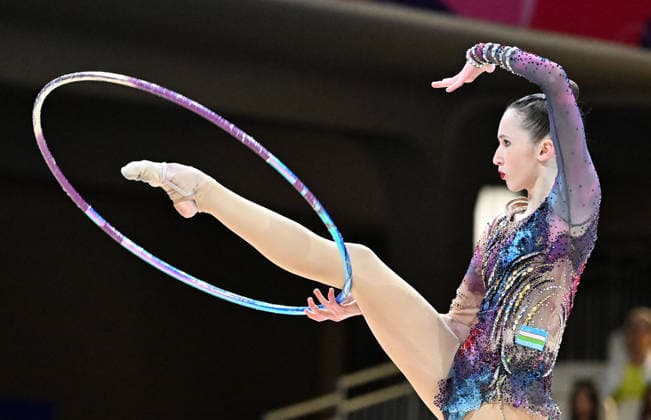 August 12, 2026, xhbx, 2026 Rhythmic Gymnastics World Championships, from left: Takhmina Ikromova, Uzbekistan, hoop routine. DFL and DFB regulations prohibit any use of photographs as image sequences and or quasi-video. Frankfurt am Main
