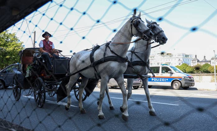 Austria Soccer UEFA Super Cup 2026, Final, Paris Saint-Germain vs. Aston Villa FC, Salzburg: On the day of the 2026 UEFA Super Cup Final between Paris Saint-Germain and Aston Villa FC, a traditional horse-drawn carriage drives through downtown Salzburg. In the background, Austrian police vehicles can be seen supporting security measures surrounding the international soccer event. Copyright: xAymanxAlahmedx