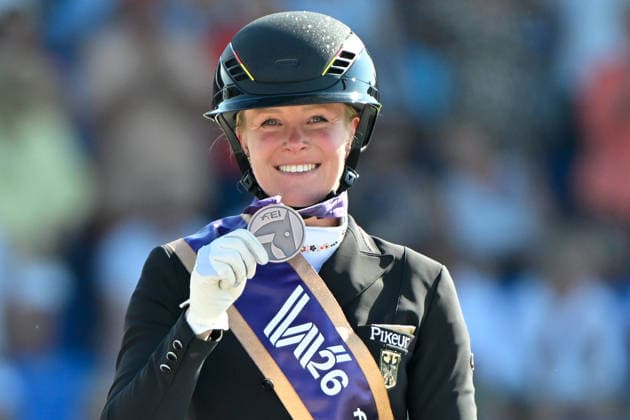 Aachen, Main Stadium, August 14, 2026, GER, FEI World Championships Aachen 2026, Meggle Prize, Grand Prix Special Dressage—Photo: Celebrations, emotion, and joy for Katharina HEMMER of Germany riding Denoix PCH after placing third and winning the bronze medal in North Rhine-Westphalia, Germany