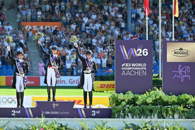 Aachen, Main Stadium, August 14, 2026, GER, FEI World Championships Aachen 2026, Meggle Prize, Grand Prix Special Dressage Photo: Award ceremony (from left) Cathrine LAUDRUP DUFOUR, Denmark, silver; Charlotte FRY, Great Britain, gold; and Katharina HEMMER, Germany, gold; North Rhine-Westphalia, Germany