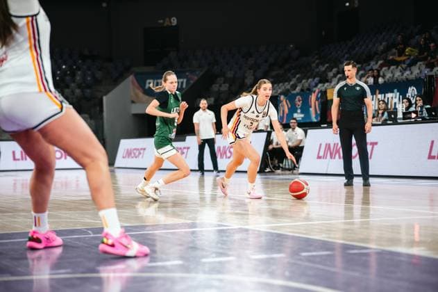A player in the 2025 Prototype Cup Germany drives the ball forward, followed by Liepa Gelzinyte 5 of Lithuania at the Pitesti Arena. A referee watches the action from the sideline as Liepa Gelzinyte 5 of Lithuania battles for the ball during the 2025 Prototype Cup Germany. Copyright: xJoelxKruehlerx