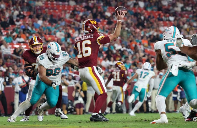 August 14, 2026, Landover, Maryland, USA: Miami Dolphins defensive tackle Alex Huntley (96) looks to sack Washington Commanders quarterback Athan Kaliakmanis (16) as he throws a pass during the NFL, American Football Herren, USA preseason game between the Washington Commanders and Miami Dolphins at Northwest Stadium on Friday, August 14, 2026; Landover, Maryland, USA. Landover USA - ZUMAs325 20260814_zsp_s325_114 Copyright: xJessxStilesx