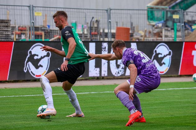 August 15, 2026, xsscx, German 3rd Division, Preußen Münster vs. FC Ingolstadt 04, Matchday 2, LVM Preußenstadion, 2026–2027 Season: Felix Higl (SC Preußen Münster, No. 33) in a tackle against Simon Lorenz (FC Ingolstadt, No. 32). DFB regulations prohibit any use of photographs as image sequences and or quasi-video. North Rhine-Westphalia, Germany