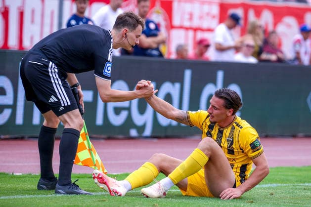 August 15, 2026, xsefx, Soccer, SC Fortuna Köln vs. TSV Alemannia Aachen, 3rd Division, Südstation, Matchday 2, 2026–2027 Season. Referee helps Petros Bagalianis get Alemannia Aachen 02 back on its feet. DFB regulations prohibit any use of photographs as image sequences and or quasi-video. North Rhine-Westphalia, Germany
