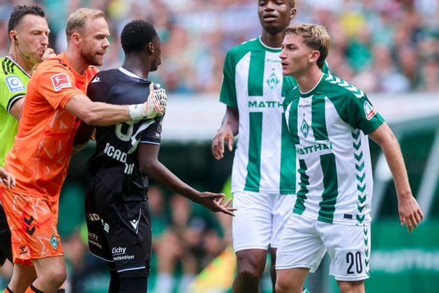 Goalkeeper Alexander Schlager of Werder Bremen, Lamfia Dioubate of AJ Auxerre, and Ivan San Jose Cantalejo Chuki of Werder Bremen clash and fight each other during the friendly match between Werder Bremen and AJ Auxerre at the Weserstadion on August 15, 2026, in Bremen, Germany. Photo by Marco Steinbrenner, DeFodi Images. Goalkeeper Alexander Schlager of Werder Bremen, Lamfia Dioubate of AJ Auxerre, and Ivan San Jose Cantalejo Chuki of Werder Bremen clash and fight each other during the friendly match between Werder Bremen and AJ Auxerre at the Weserstadion on August 15, 2026 in Bremen, Germany Photo by Marco Steinbrenner, DeFodi Images Photo by Marco Steinbrenner, DeFodi Images