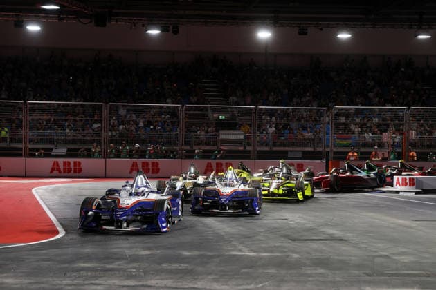 Pascal Wehrlein (GER) in Porsche 94 and Nico Mueller (SUI) in Porsche 51 lead Race 1 after Turn 1, FIA Formula E World Championship, Season 12, London E-Prix, August 15, 2026, Excel Exhibition Center