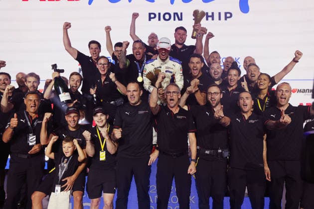 Pascal Wehrlein (GER) in a Porsche 94, wearing a white jumpsuit, Nico Mueller (SUI) in Porsche 51, Michael Steiner (GER), Member of the Executive Board of Porsche AG, and David Beckmann (GER), reserve driver and team member, in the group photo with the winners, Race 1, FIA Formula E World Championship, Season 12, London E-Prix, August 15, 2026, Excel Exhibition Center