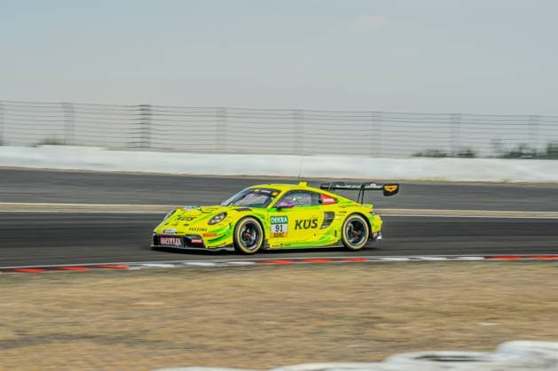 The Manthey Racing Porsche 911 GT3 R 91, with Thomas Preining at the wheel, races around the Nürburgring circuit in Nürburg. The neon yellow-green car is adorned with the logos of sponsors KÜS, Motul, and Veltins. Thomas Preining’s Manthey Racing Porsche 911 GT3 R 91 at the Nürburgring Copyright: xMichaelxSchäferx