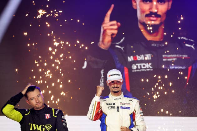 Second-place Jake Dennis (GBR) of Andretti looks disappointed next to Pascal Wehrlein (GER) in the Porsche 94, raising his fist in victory on the podium, Race 1, FIA Formula E World Championship, Season 12, London E-Prix, August 15, 2026, Excel Exhibition Center,