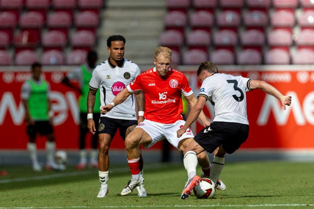 GER, Mainz, Soccer, Friendly Match, FSV Mainz 05 vs. AFC Bournemouth (pictured, from left): Andreas Hanche Olsen (FSV Mainz 05, 25), Adrien Truffert, AFC Bournemouth 03, tackle, August 15, 2026, MEWA Arena, Mainz. DFL and DFB regulations prohibit any use of photographs as image sequences and or quasi-video, Copyright: HMBxMedia PaulxFritz